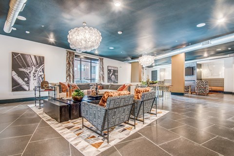 A modern living room with a large sofa set and a chandelier.